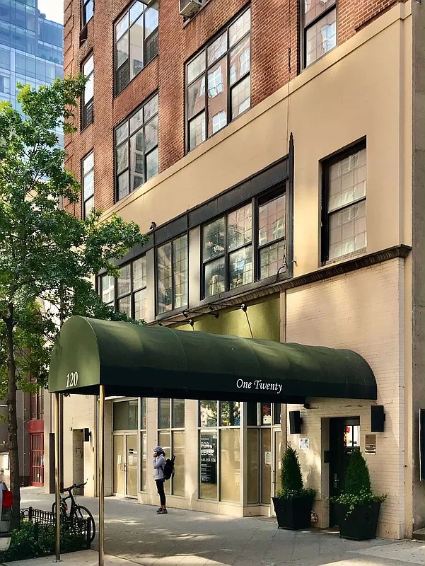 Green awning at the entrance of the office building at 120 East 86th Street